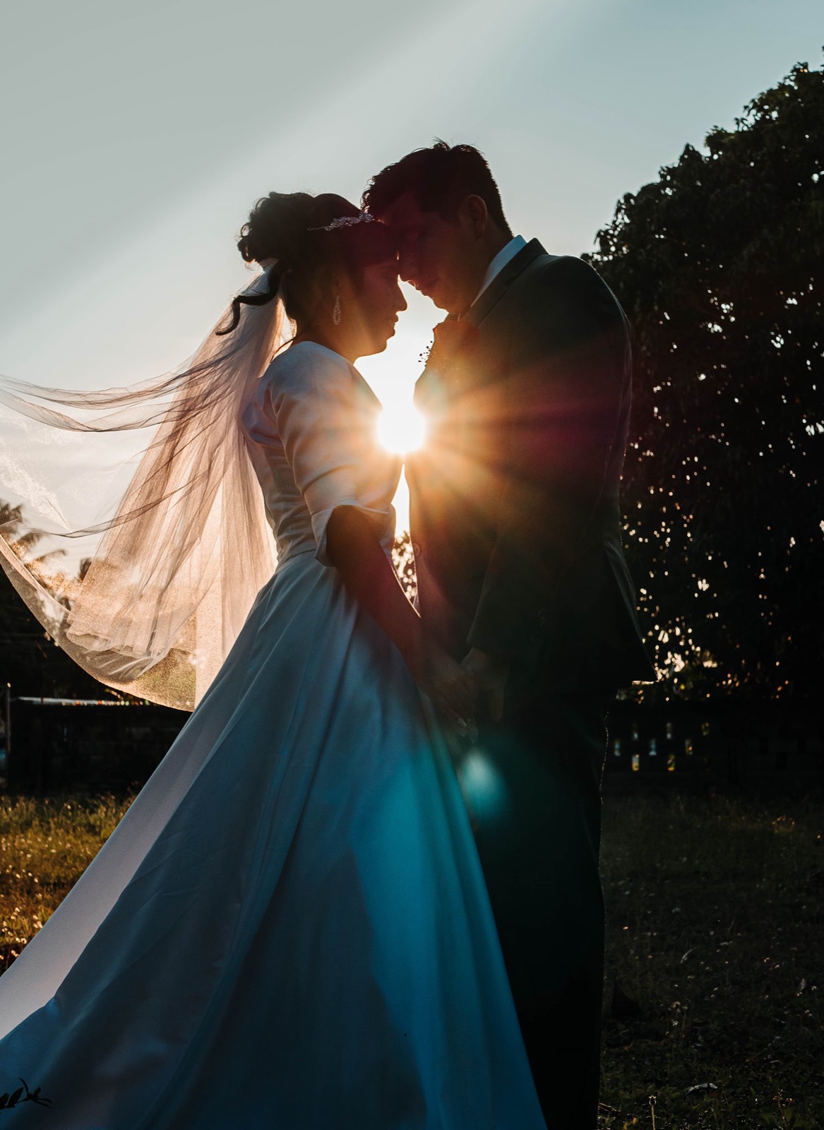 Couple silhouetted against the setting sun